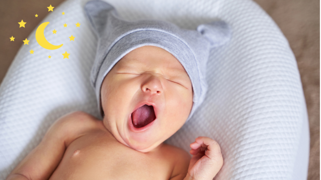 bebê de gorro bocejando com sono