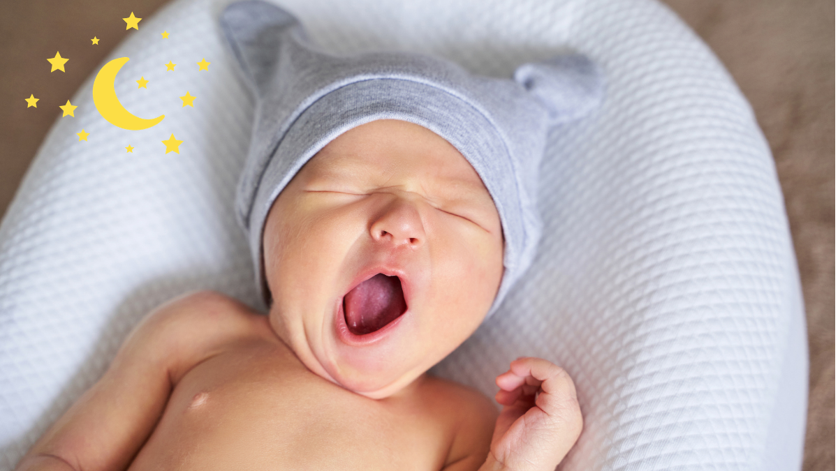 bebê de gorro bocejando com sono